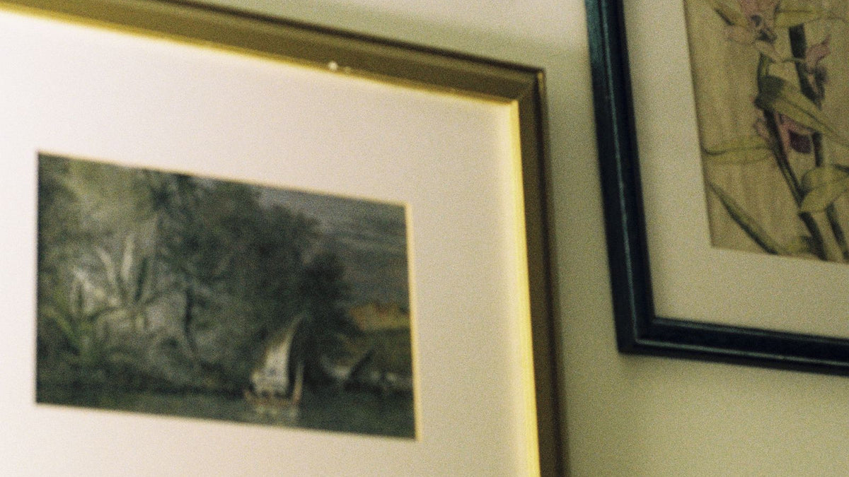 Framed artwork arranged as a thoughtful small-space pet memorial gallery wall