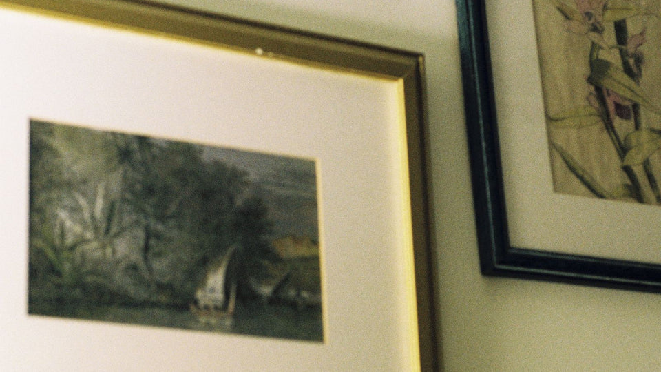 Framed artwork arranged as a thoughtful small-space pet memorial gallery wall